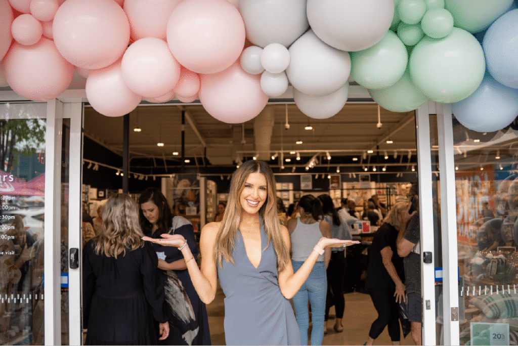 Smiling guest under balloon arch at Pillow Talk opening, documented by Brisbane event photographer.